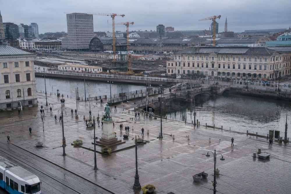 Railway tracks and construction works near Gothenburg Central Station with cranes against a grey Nordic sky