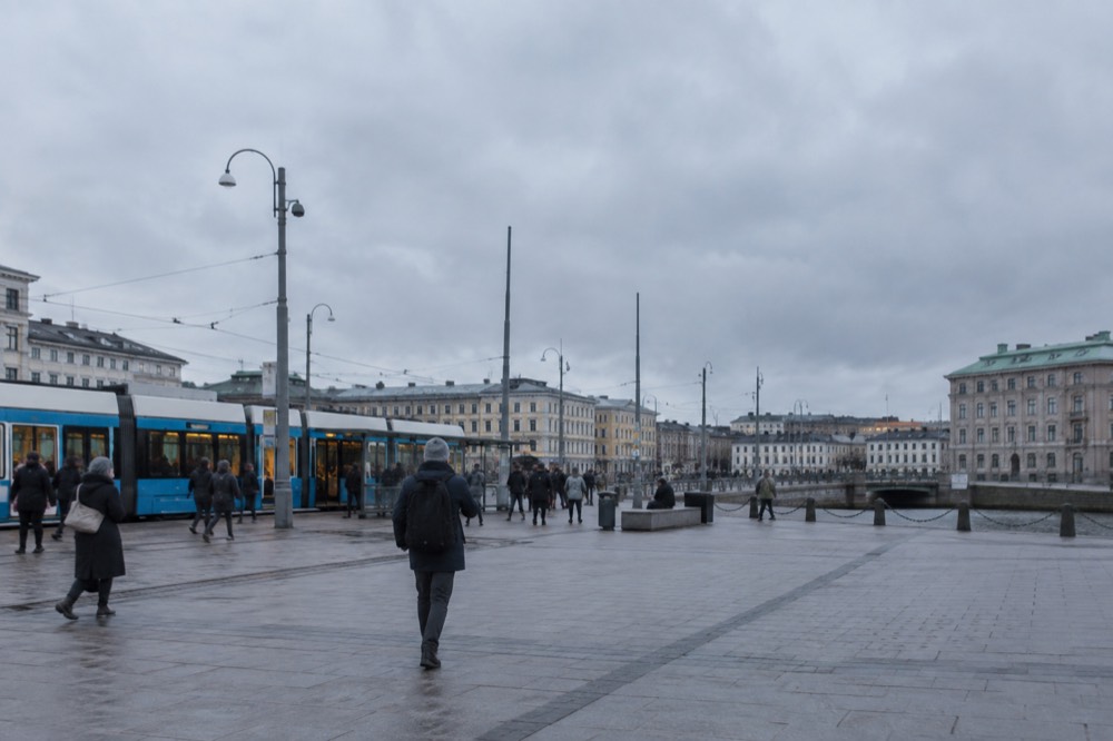 Trams and pedestrians outside Gothenburg Centralstation on a grey Nordic day