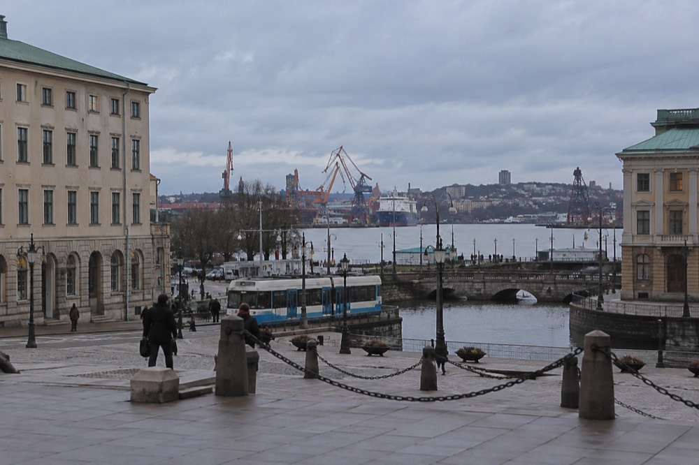 A view over Gothenburg rooftops toward the Göta älv river and harbour cranes