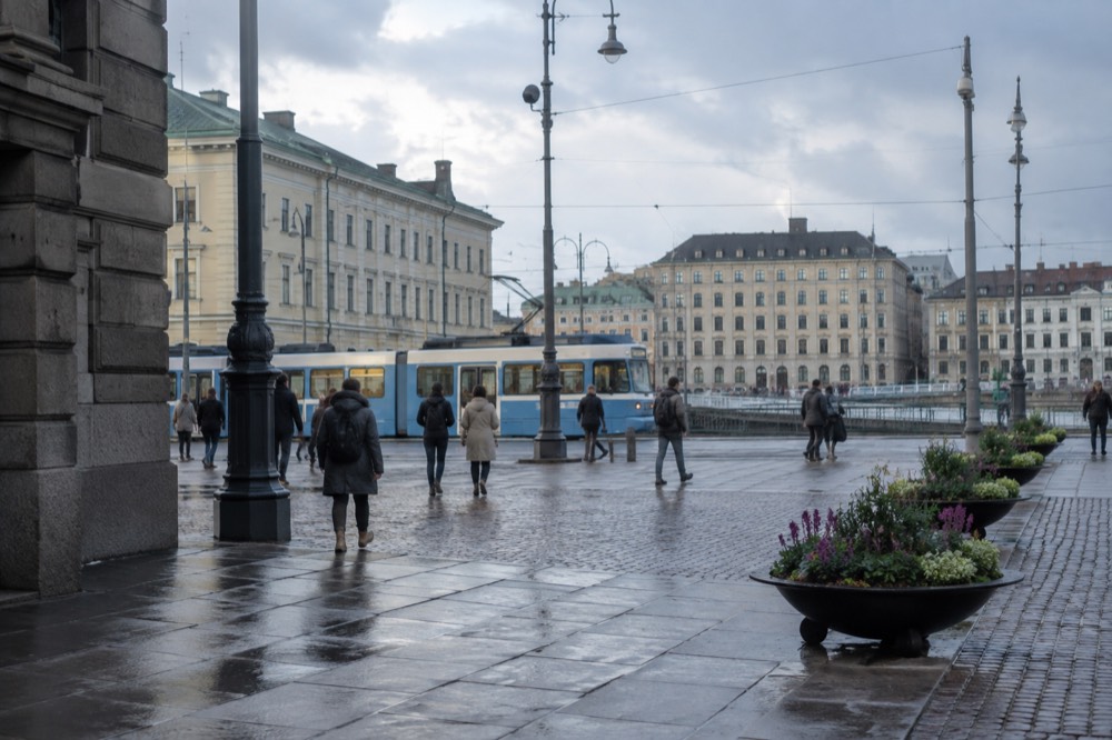 A Västtrafik tram moving along a street in central Gothenburg past stone buildings