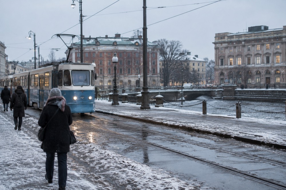 Gothenburg's red brick buildings and a tram under pale winter light on a snowy street