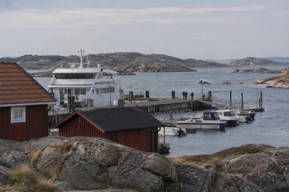 Red wooden boathouses and smooth granite rocks on a car-free island in the Gothenburg archipelago