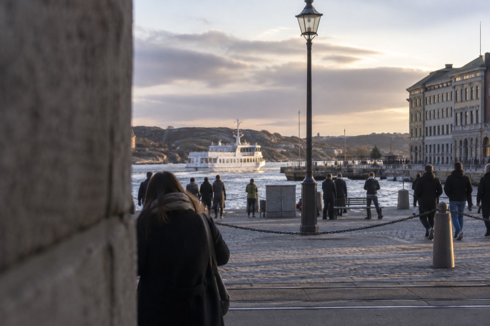 A white passenger ferry approaching a rocky island quay in the Gothenburg archipelago