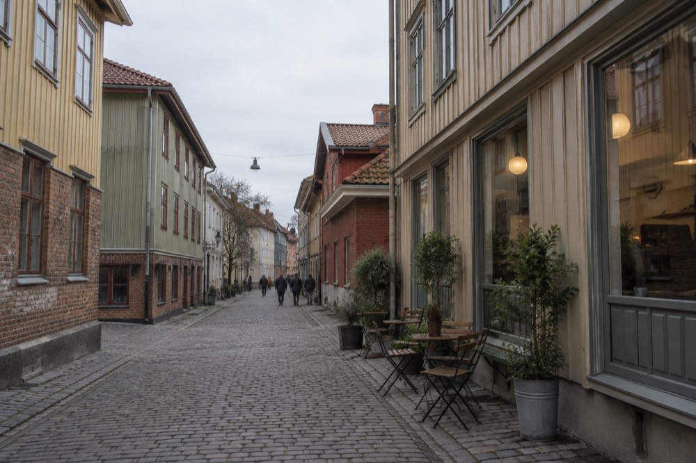 Wooden shopfronts and cobblestone street in the Haga quarter of Gothenburg