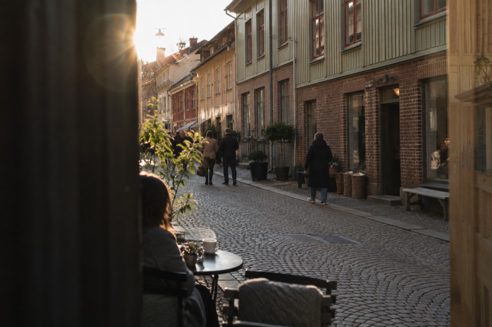 Pedestrianised Haga Nygata street with rounded cobblestones, small shopfronts and people browsing