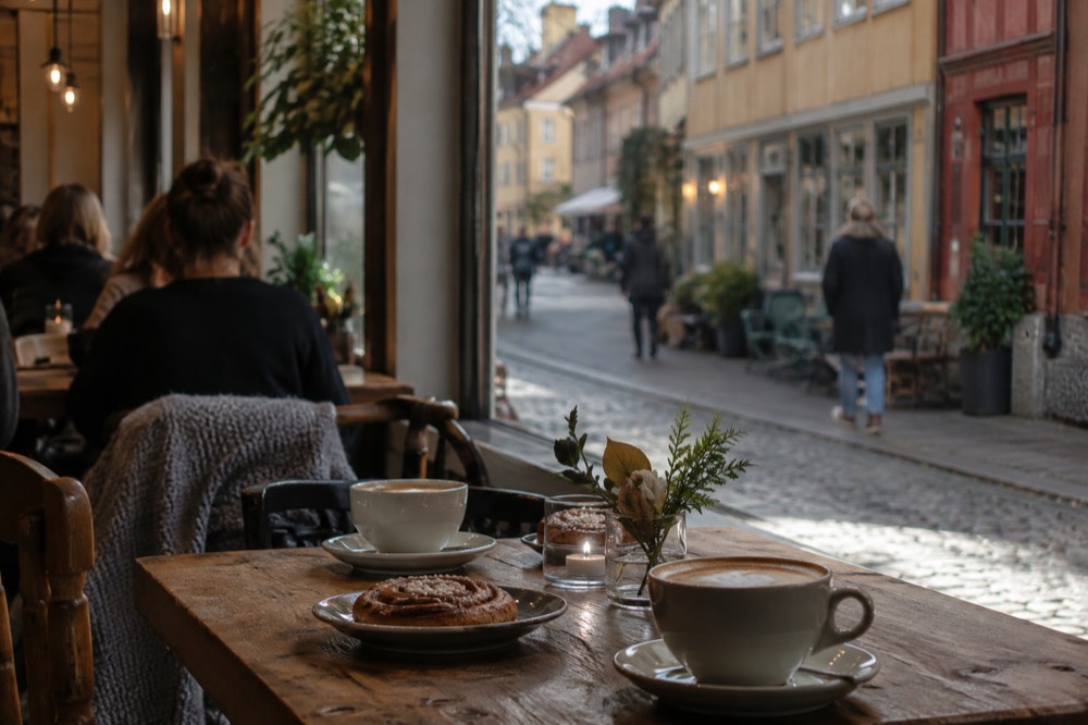 Café interior in Haga with coffee cups, cinnamon buns and wooden tables