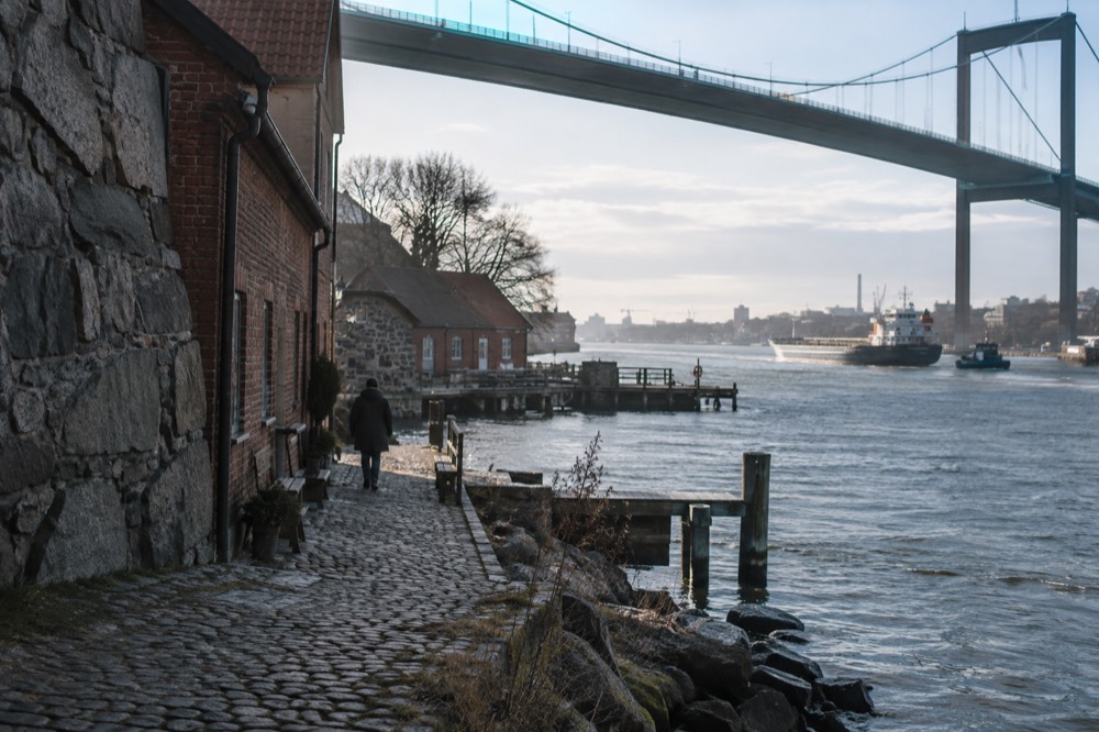 The Göta älv river seen from Klippan with ships passing the old harbour buildings