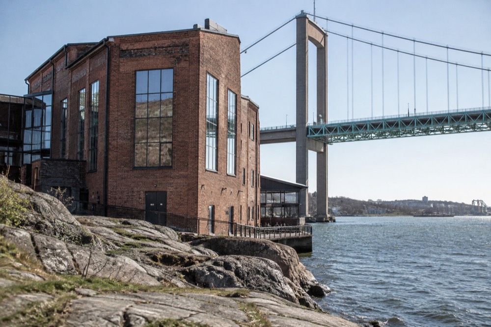 Converted harbour buildings on the Röda Sten quay with the bridge towers behind