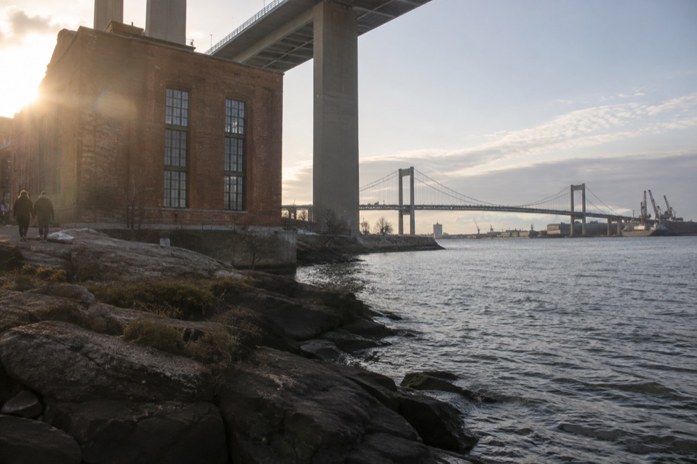 The suspension towers of the Älvsborg Bridge seen from the water with harbour industry behind