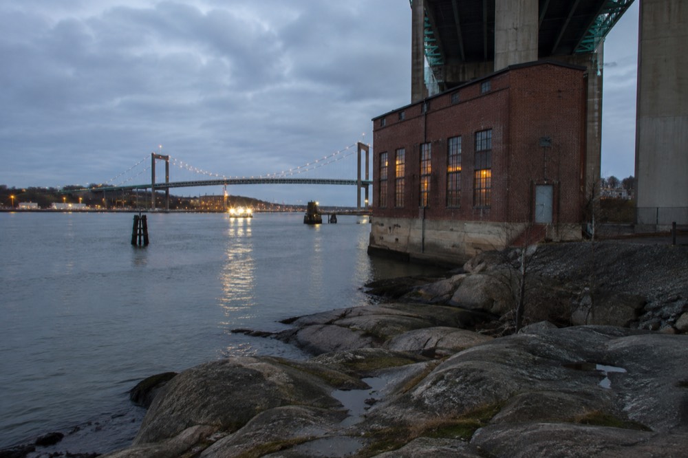 The river mouth at dusk with the Älvsborg Bridge lights and calm water