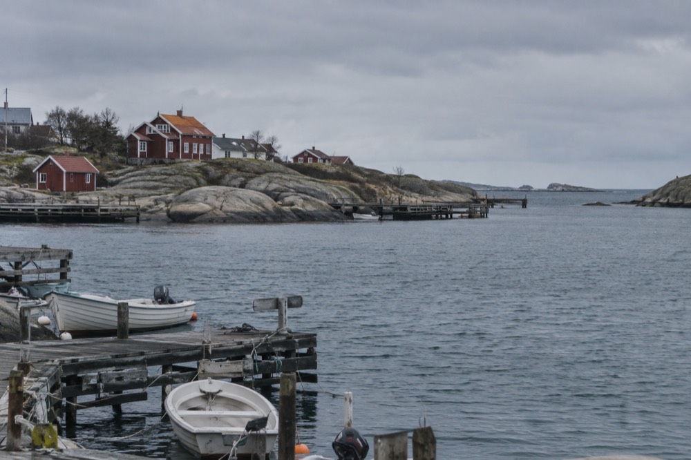 Wooden holiday cottages painted red among granite rocks on a car-free island