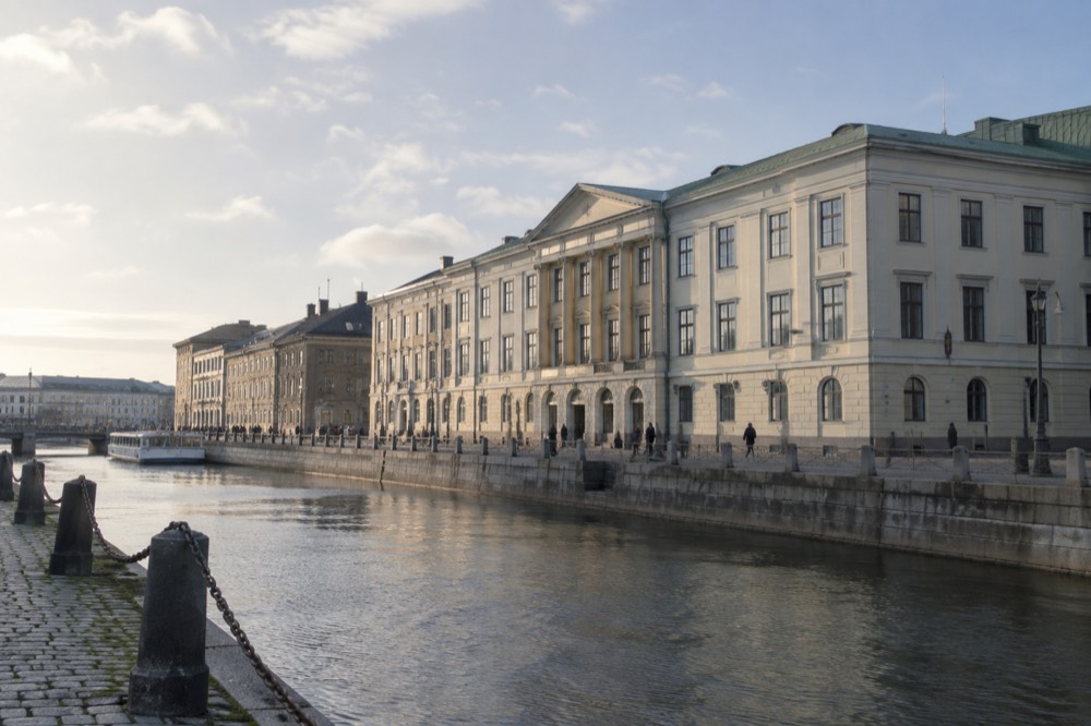 The stone facade of the Gothenburg City Museum seen from the canal side on a bright afternoon