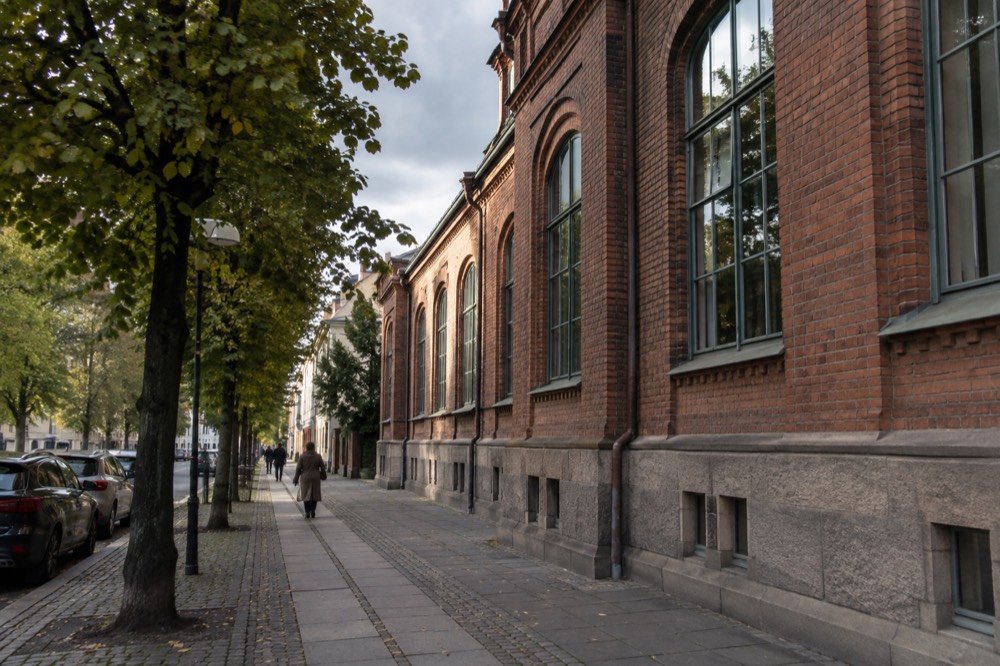 The brick facade of a Gothenburg museum building on a city street under a grey Nordic sky