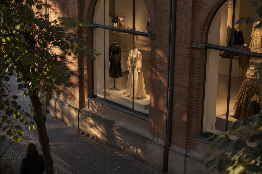 Textile and fashion garments displayed on mannequins inside a museum gallery