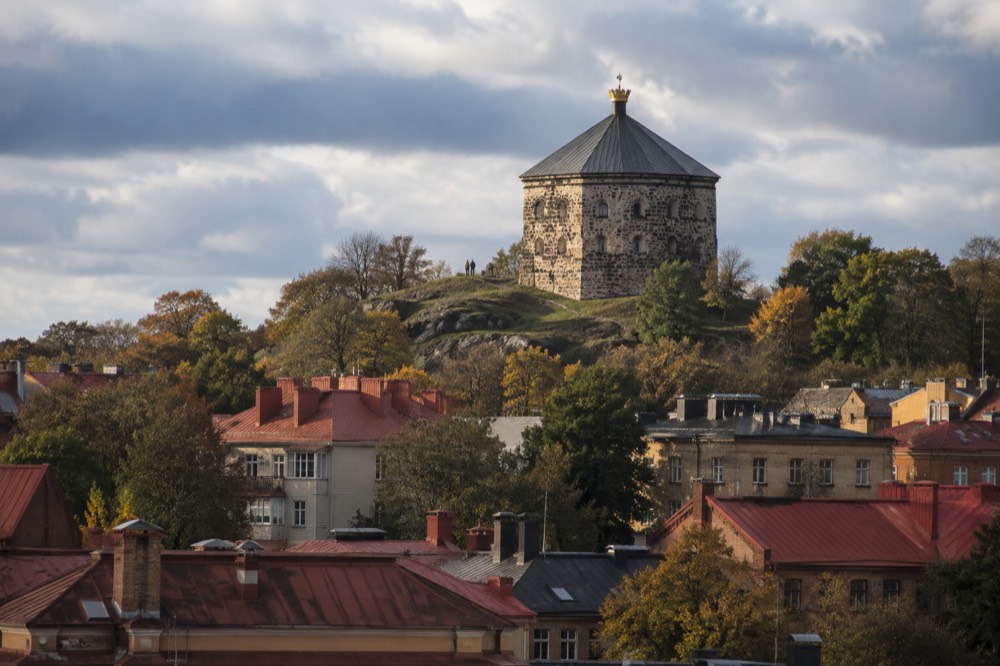 Stone fortification tower on a wooded hill above Gothenburg's rooftops