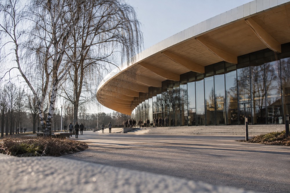 An empty exhibition hall with Volvo cars in soft morning light