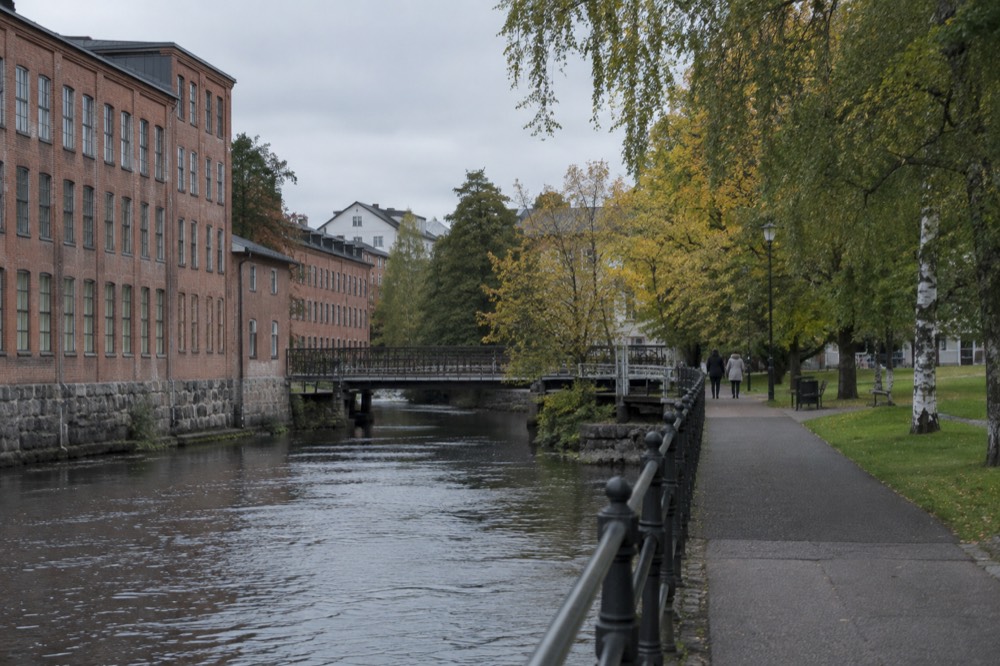 Large colourful mural painted on the side of a building in a Swedish town centre under a grey sky