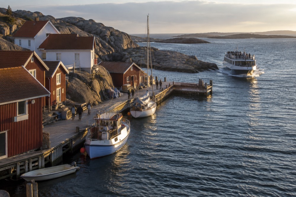 A passenger ferry approaching a small car-free island jetty