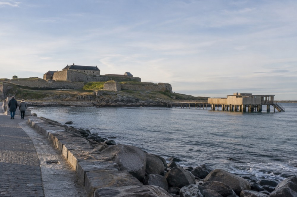 The stone walls and green ramparts of Varberg fortress in morning light