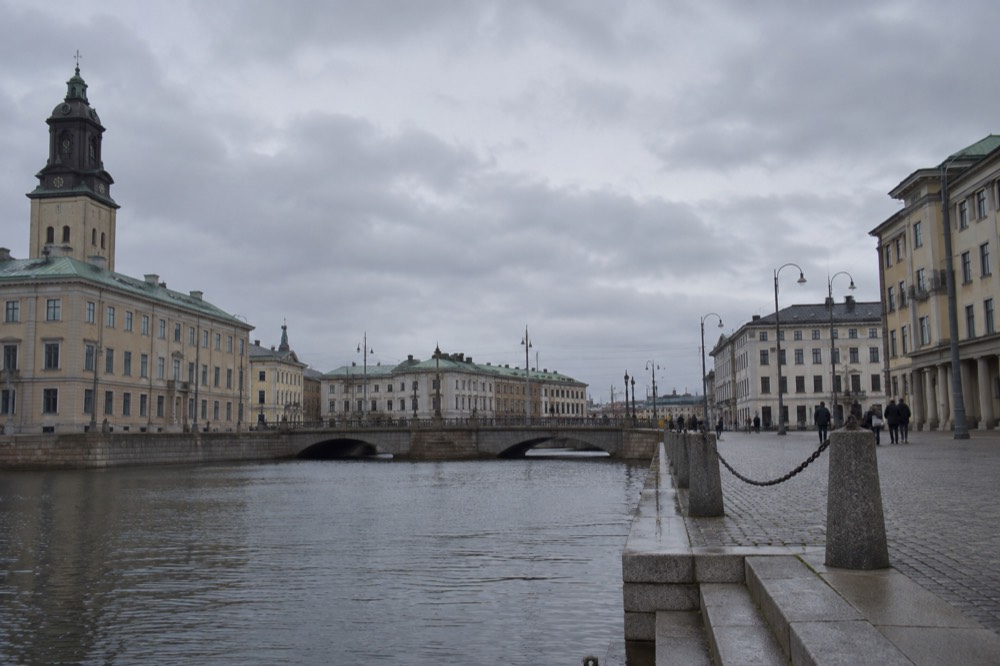 Gothenburg canal with a bridge and historic buildings under a soft sky