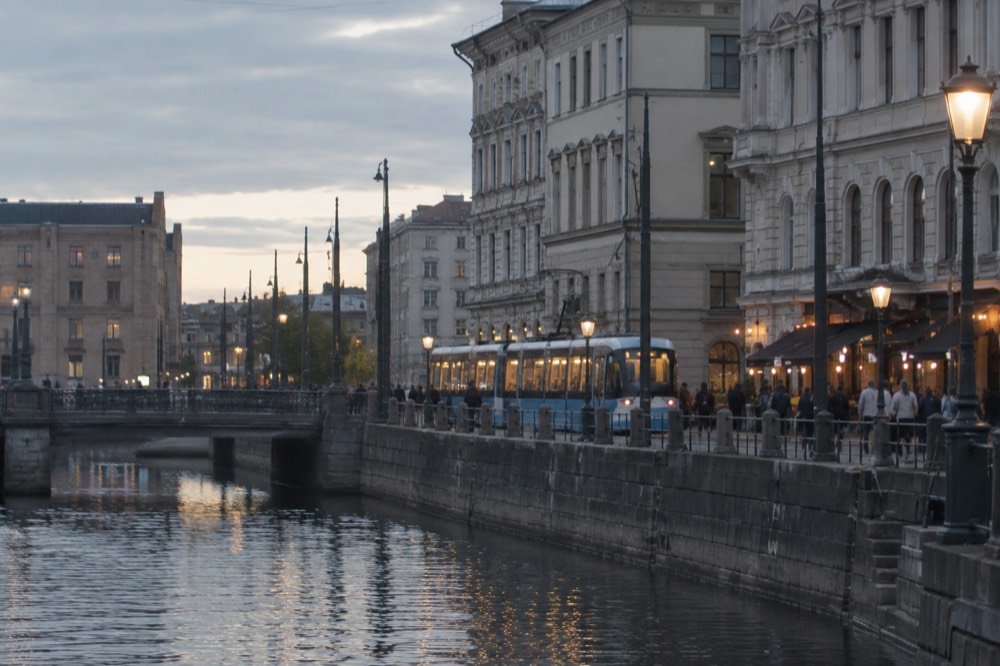 A Gothenburg tram passing a bar street at dusk