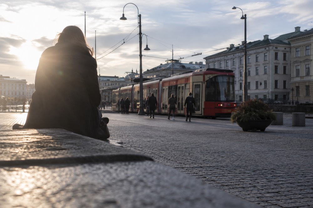 A red Gothenburg tram at a street stop in the city centre