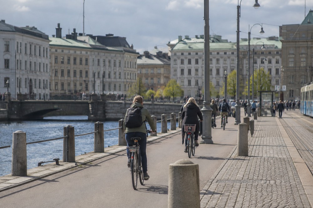 Cyclists on a separated bike lane beside a canal in central Gothenburg