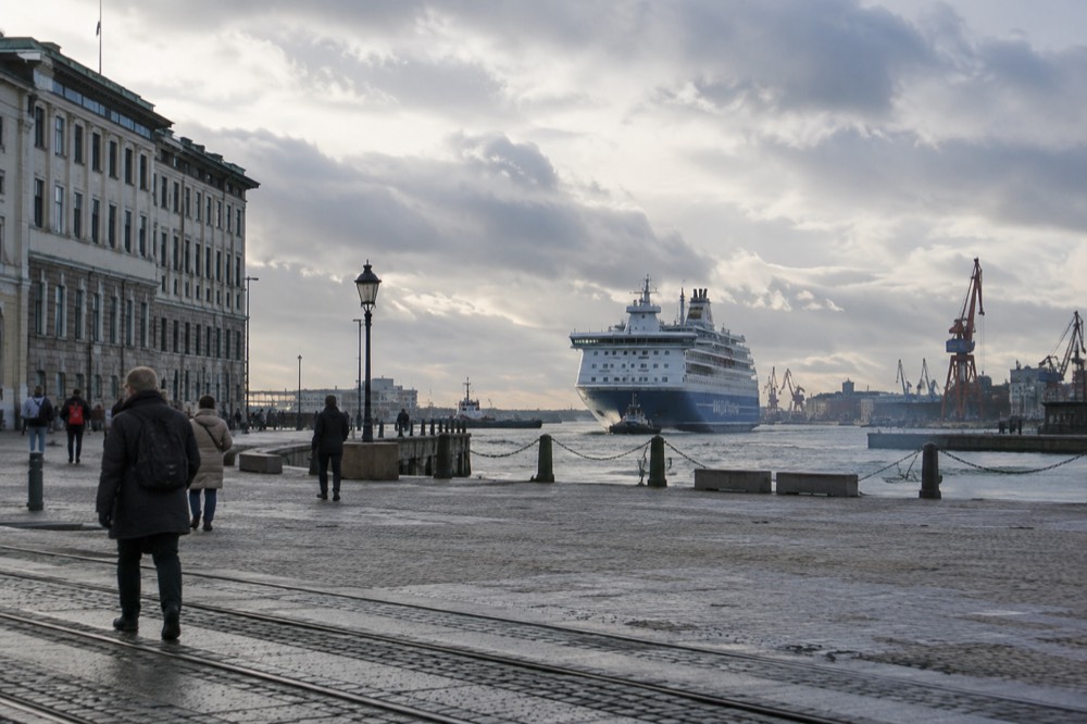 A large passenger ferry approaching the Gothenburg quayside in grey morning light