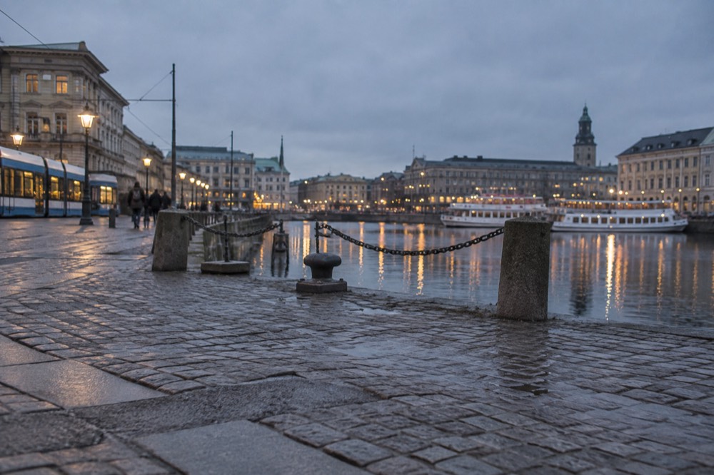 Gothenburg city lights reflecting in the harbour water at dusk