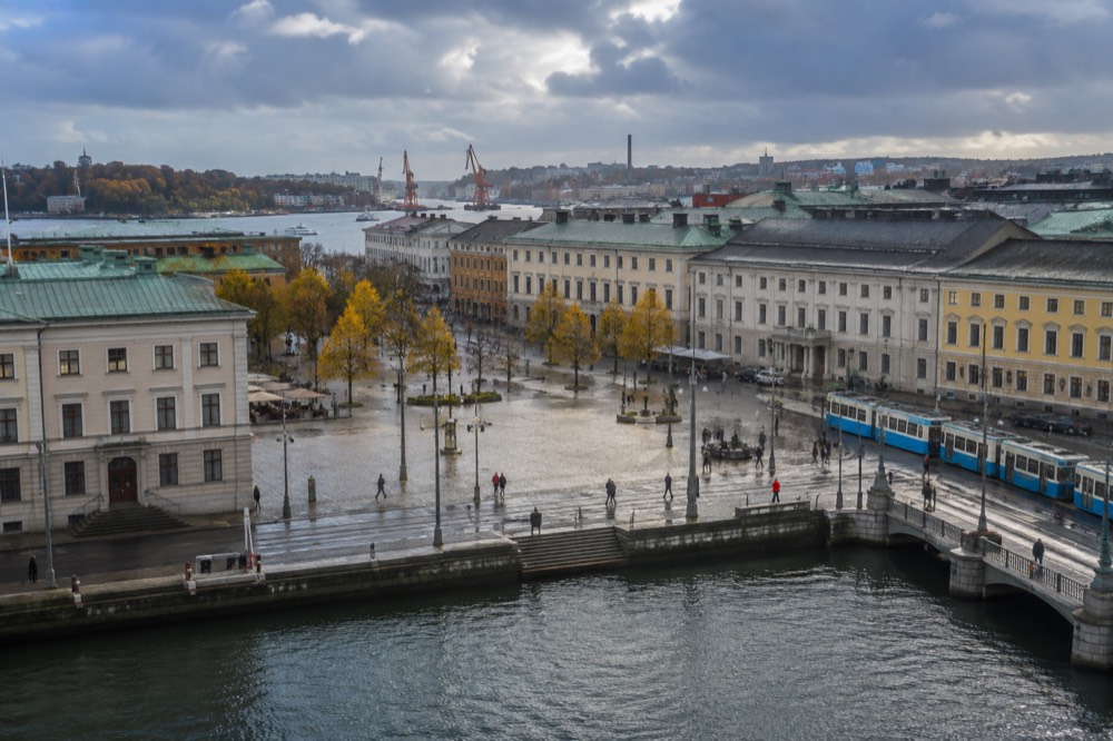 Rain clouds over red brick rooftops in Gothenburg with the Göta älv in the foreground