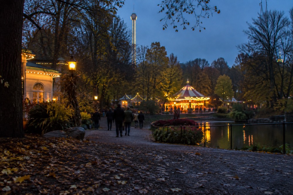 Halloween decorations and a lit carousel at Liseberg amusement park in autumn