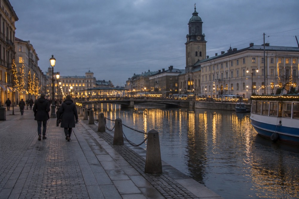 Gothenburg's Christmas-lit canal at dusk with reflections on dark water