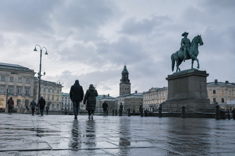 Visitors inside a warm, glass-roofed museum hall in Gothenburg