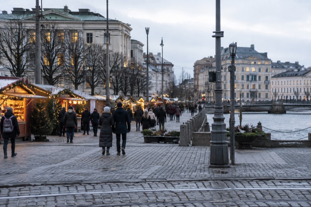 Christmas market stalls with warm lights along a Gothenburg street