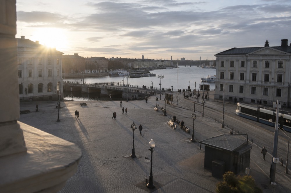 Long evening light over Gothenburg rooftops with the Göta älv river in the distance