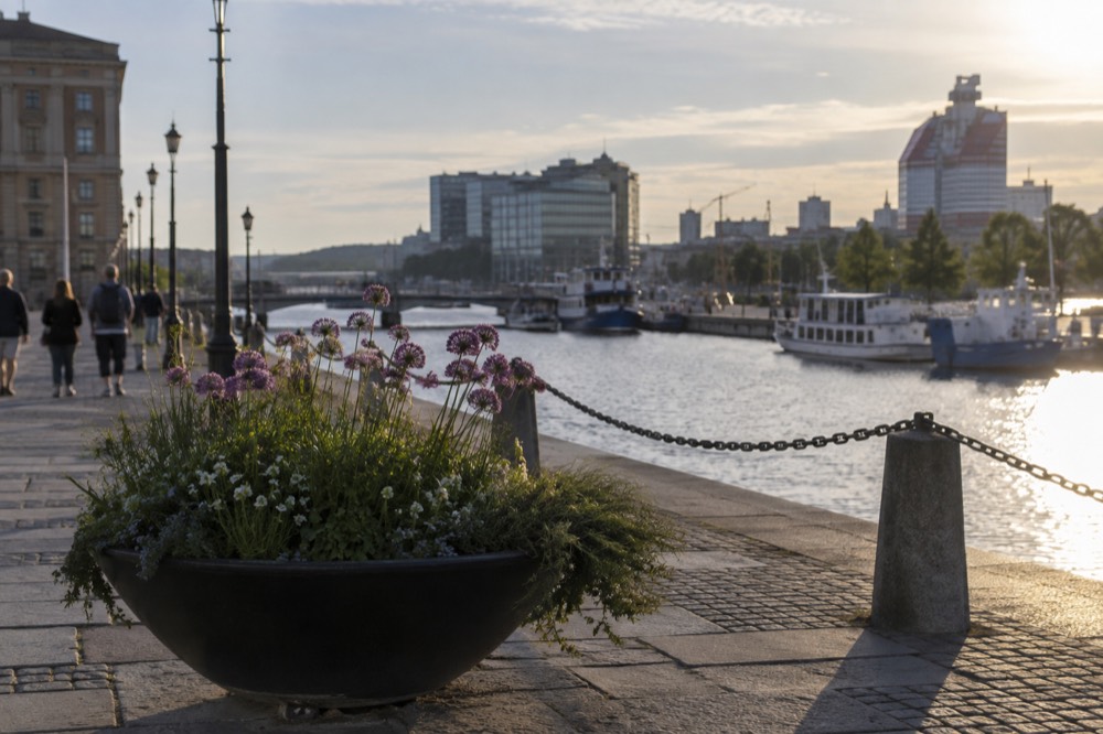 Sunlight over the Göta älv river in Gothenburg with harbour boats and glass buildings