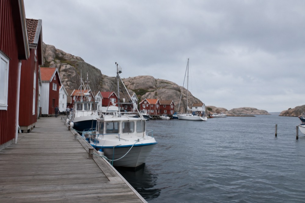 Granite coast and small red boathouses along the Bohuslän shoreline in summer