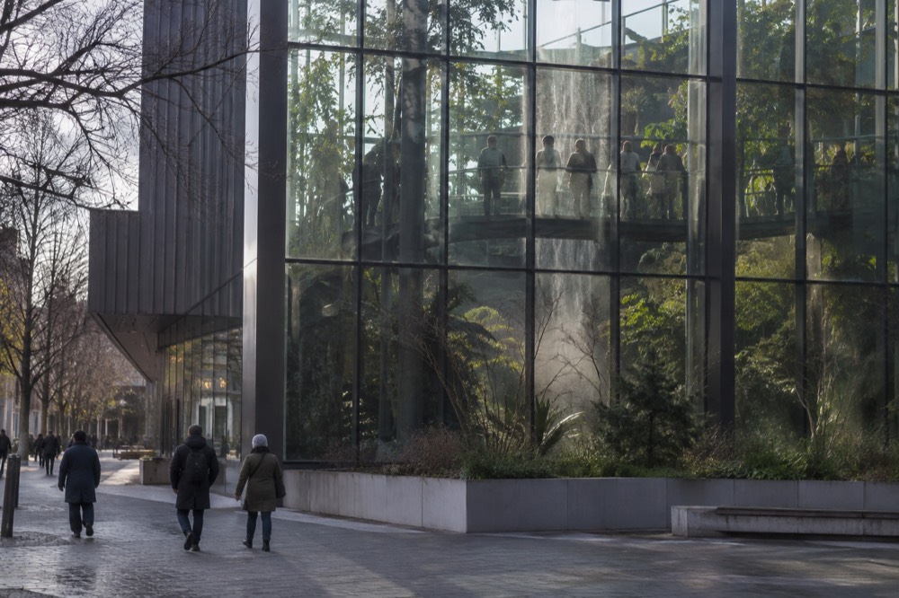 Visitors inside the rainforest hall at Universeum with tall trees and a walkway