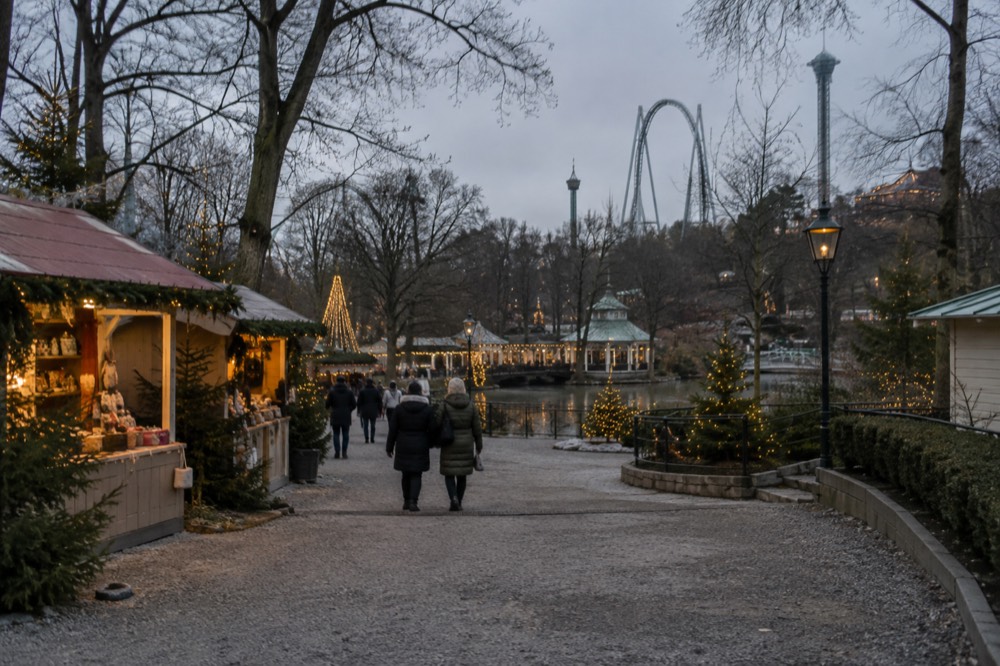 Christmas lights and market stalls inside Liseberg at dusk