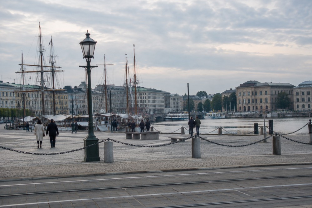 Historic sailing ships and vessels moored at a dock in the river