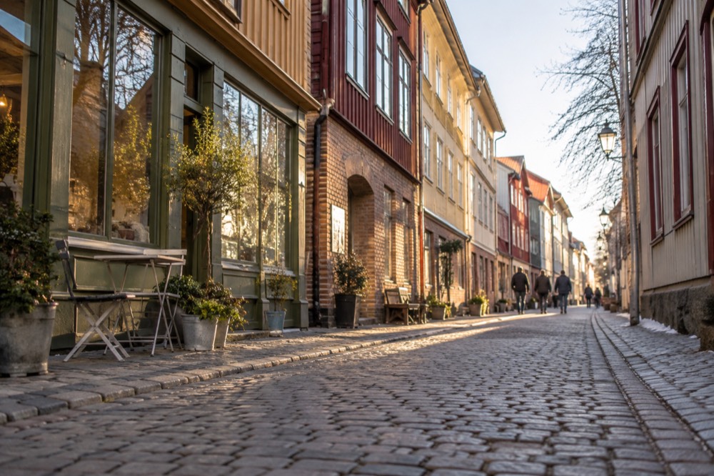 Wooden shopfronts and cobbled street in the Haga old quarter of Gothenburg