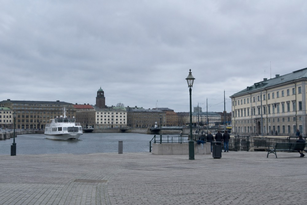 A white archipelago ferry approaching a wooden jetty on a small Swedish island