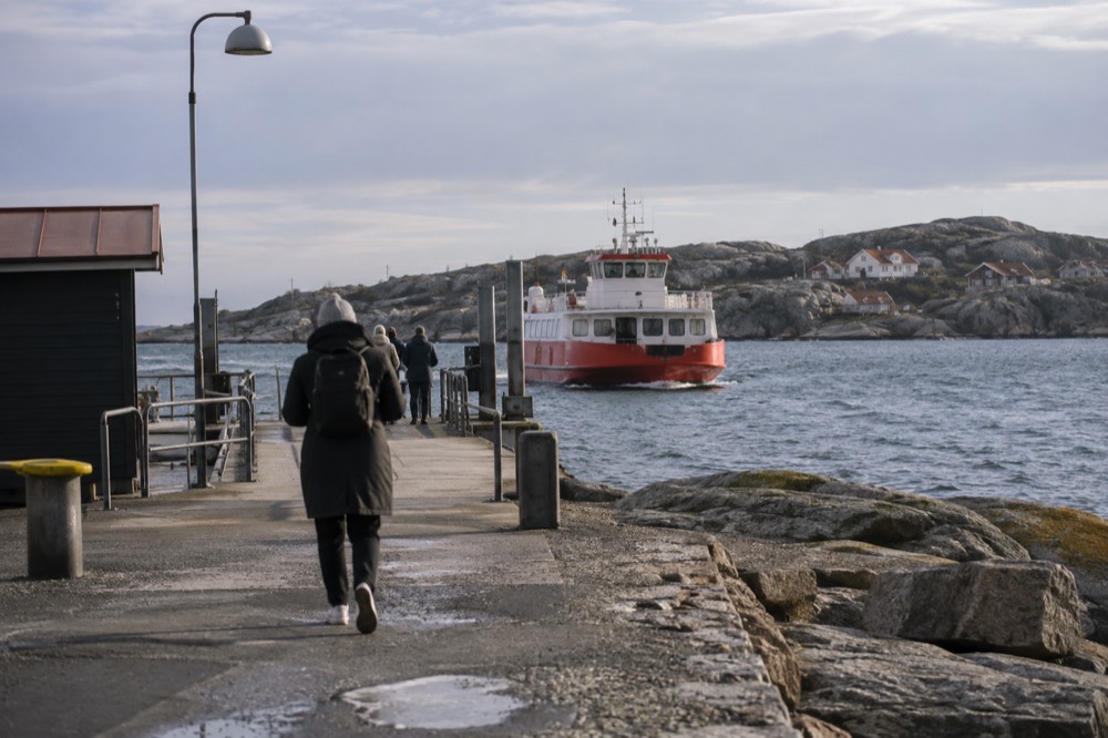 Red ferry approaching a rocky car-free island in the Gothenburg archipelago