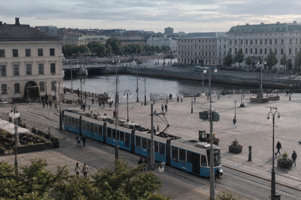 A blue Gothenburg tram passing through the city centre near the central station