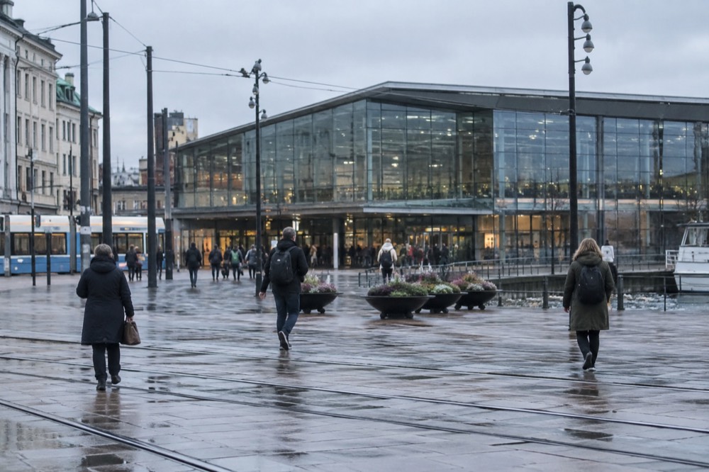 The modern glass front of Oslo Central Station with pedestrians outside