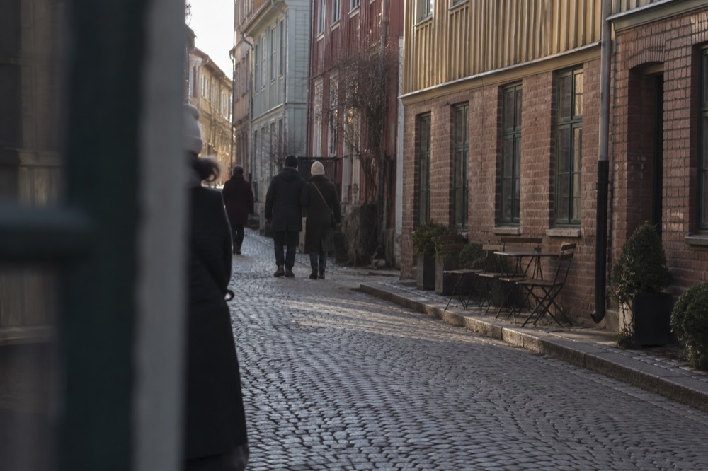 Painted wooden houses on a cobbled street in the Haga quarter of Gothenburg