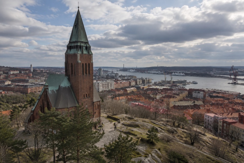 Masthuggskyrkan church standing on a hill above red rooftops and the Göta älv river in Gothenburg