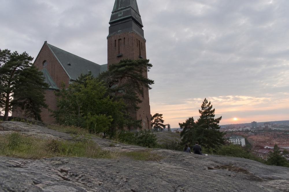 Late evening light over Gothenburg rooftops with the sun still above the horizon at 10pm in June