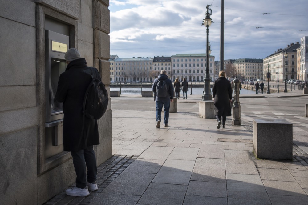A street bankomat ATM beside a stone building facade in central Gothenburg