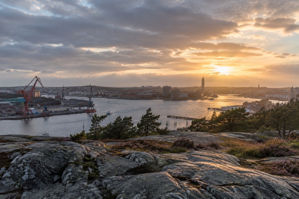 View from Ramberget across the Göta älv river towards the Gothenburg city skyline at golden hour
